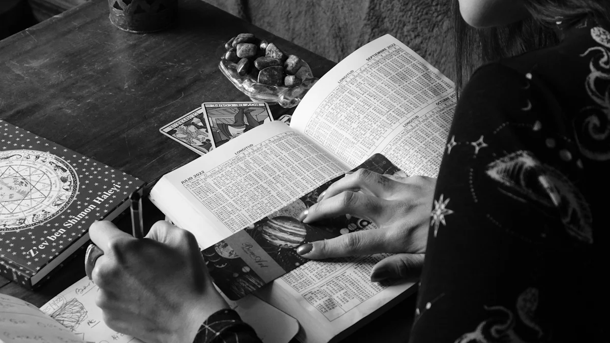Astrologia ca instrument pentru găsirea vocației ideale 1 O persoană este absorbită în a citi o carte la o masă împodobită cu cărți de tarot, un ghid de astrologie și un castron de pietre. În apropiere, o ciornă automată se odihnește discret, adăugând o prezență enigmatică decorului mistic.